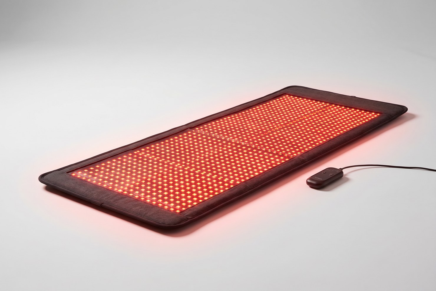 The full Luscent red and infrared light therapy LED mat laid flat with every LED glowing